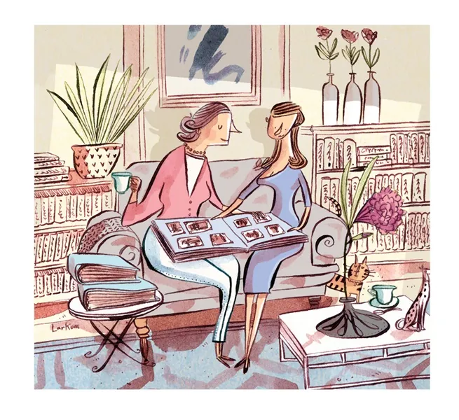 Two women on couch looking at photo album in living room by Adam Larkum