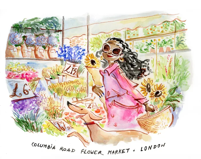 Woman with sunglasses at Columbia Road Flower Market holding sunflowers