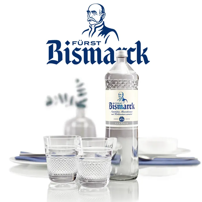 Bottle of Fürst Bismarck clear spirit with two filled shot glasses