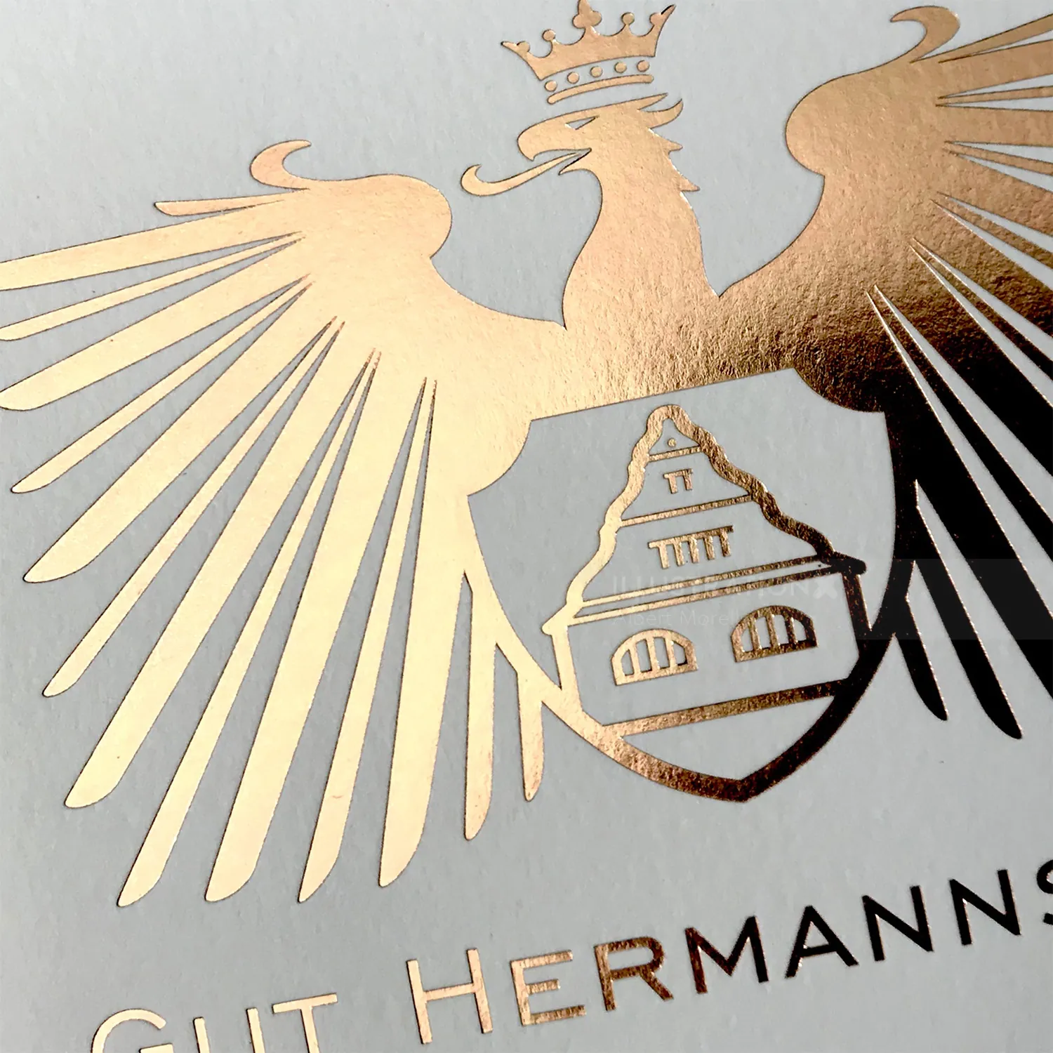 Gold foil embossed eagle emblem with crown and shield design