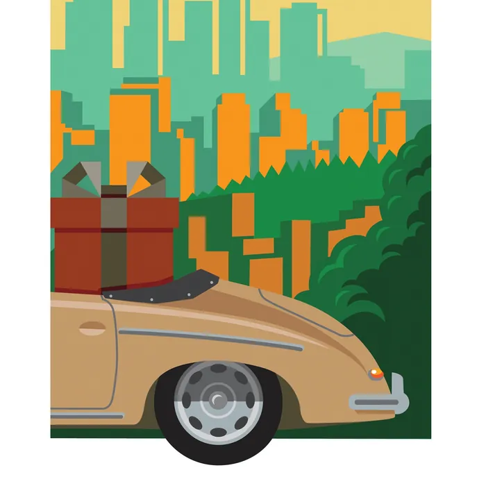 Rear of vintage car with luggage set in front of city skyline and greenery