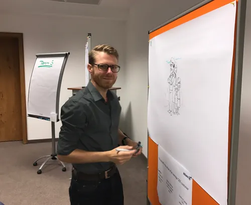 Man drawing detailed sketch on large paper pad Alexander Roncaldier