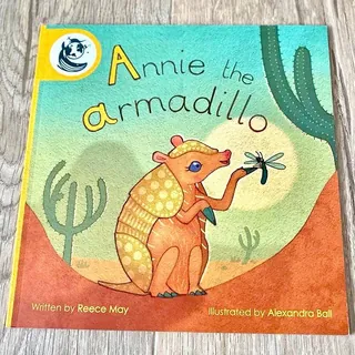 Cover of Annie the armadillo book with armadillo holding a dragonfly in desert