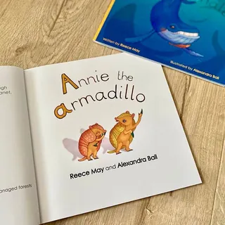 Open book showing title Annie the Armadillo with two armadillo illustrations