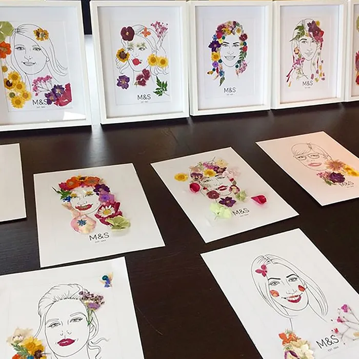 Framed flower portraits displayed on table at The Ivy