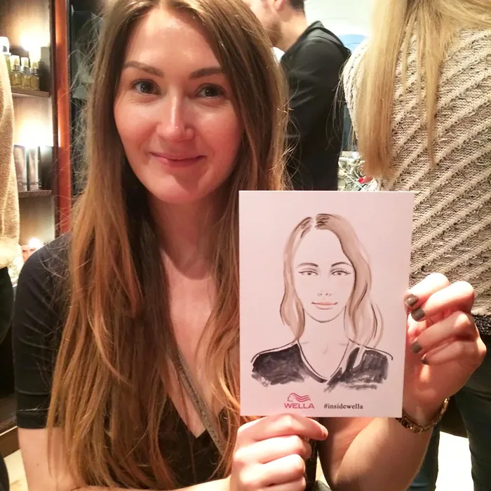 Woman holding her caricature portrait at Wella event