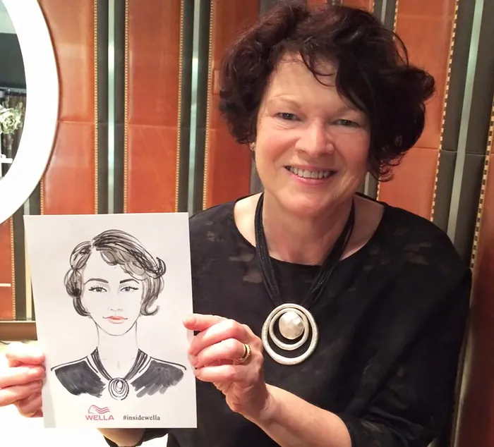 Smiling woman holding caricature portrait at event
