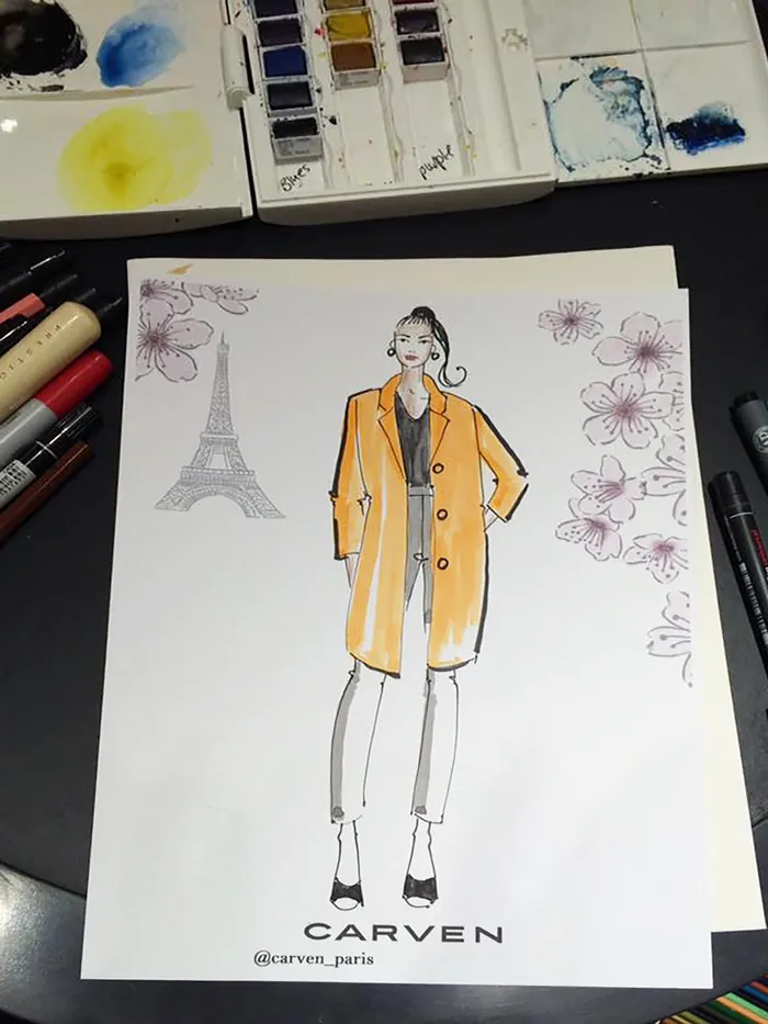 Fashion sketch of woman wearing orange coat with Eiffel Tower drawing