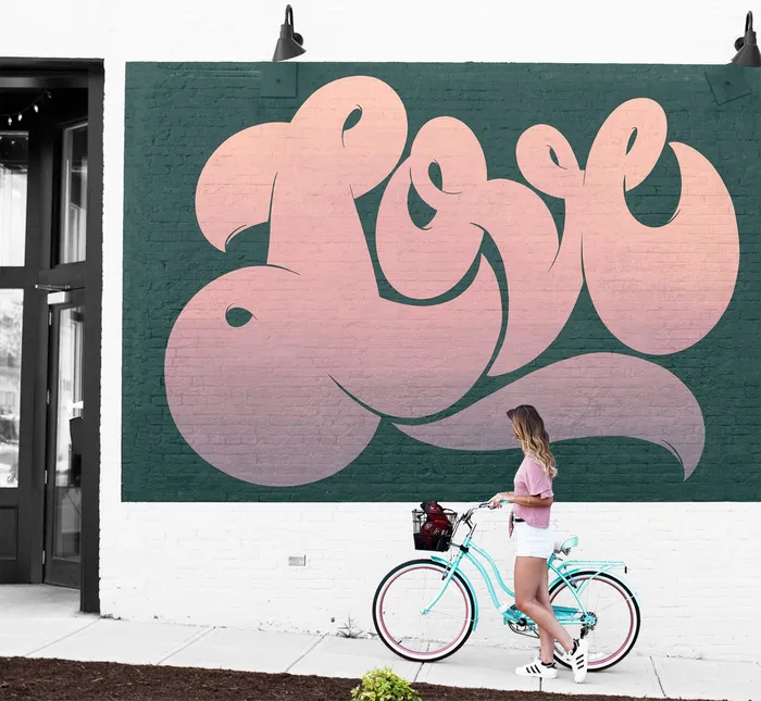 Graphic lettering Girl with bicycle at love sign
