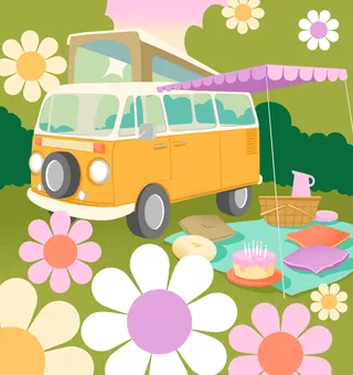 Yellow VW van picnic setup with colorful flowers and cushions