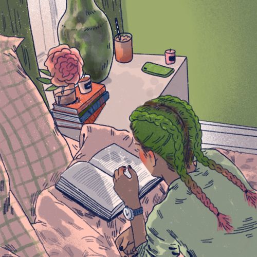 Individual reading a book lying on a bed with green walls and nightstand