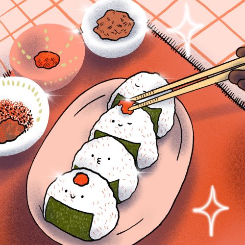 Onigiri rice balls on plate with chopsticks holding one
