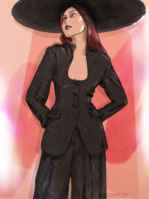 Woman wearing black suit and large black hat posing confidently