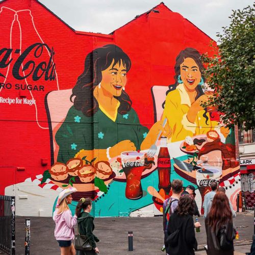 Mural showing family dinner with Coca-Cola bottles and food