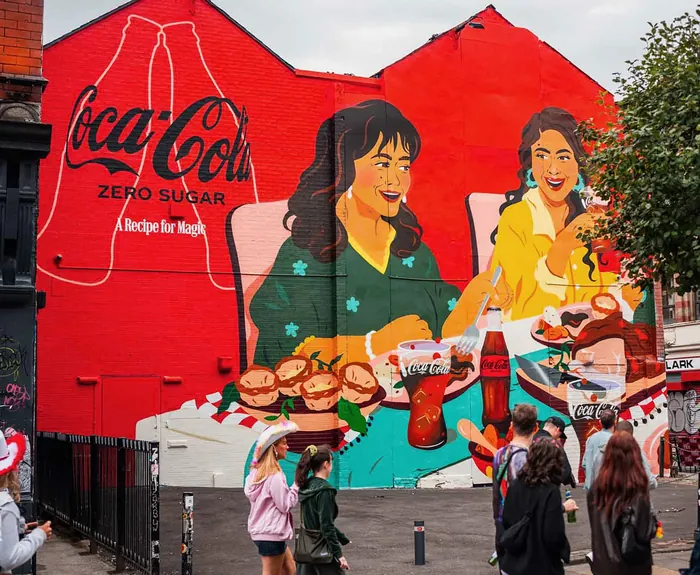 Mural showing family dinner with Coca-Cola bottles and food