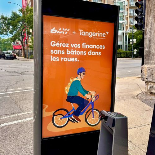 Illustration of a person riding a bike on an orange Tangerine Bank ad