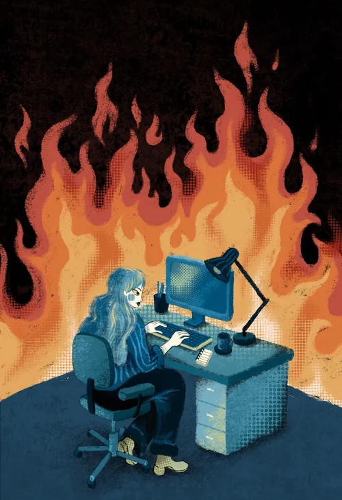 Person arbeitet an einem Computertisch vor Flammen im Hintergrund (Foto: Alyssa De Asis)