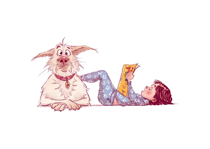 Child reading book next to friendly dog lying on floor