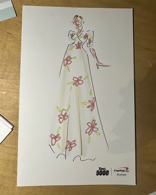 Fashion sketch of woman in floral dress on branded paper