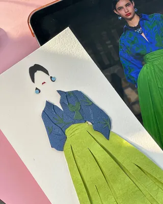 Paper art fashion illustration with blue top and green skirt