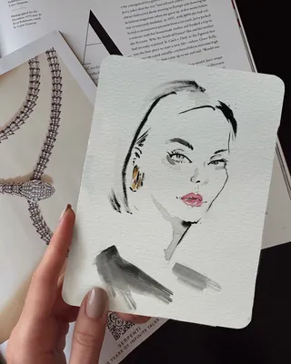 Hand holding watercolor portrait fashion illustration of woman