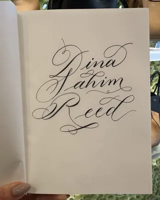 Elegant handwritten calligraphy of Dina Sahim Reed