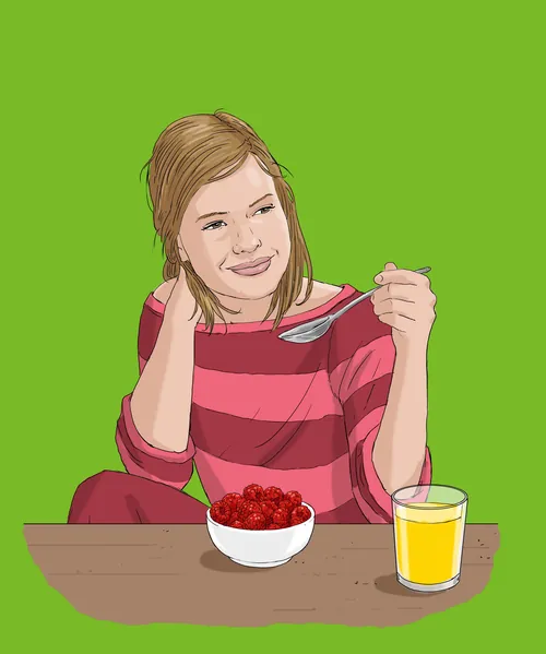 Woman eating raspberries from a bowl with a glass of juice by Andreas Schickert