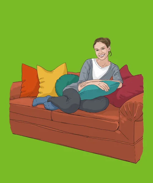 Woman relaxing on brown sofa with colorful pillows by Andreas Schickert