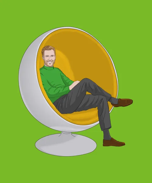 Man in green sweater sitting in modern egg chair by Andreas Schickert
