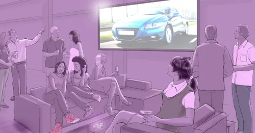 Group watching a car presentation on screen by Andreas Schickert