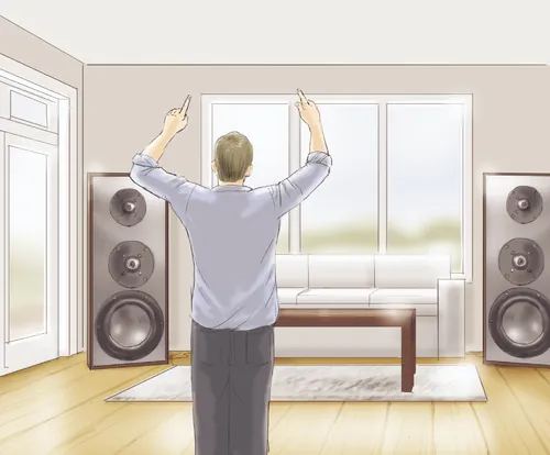 Man adjusting floor-standing speakers in a living room by Andreas Schickert
