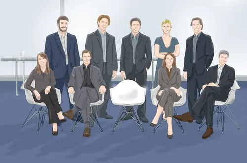 Nine professionally dressed people posing indoors with modern chairs by Andreas Schickert