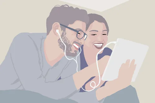 Couple sharing earphones and tablet device by Andreas Schickert