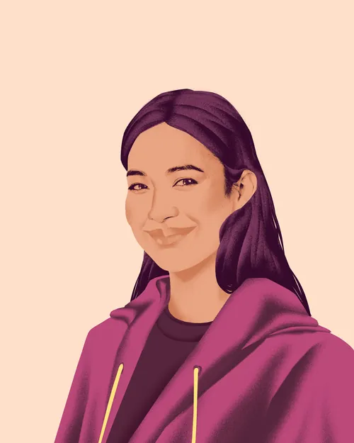 Smiling woman with long dark hair in maroon hoodie on light background