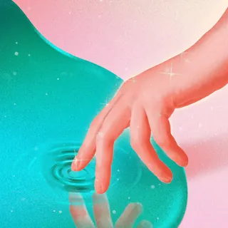 Human hand touching blue water creating ripple effect