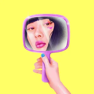 Woman's face with pink makeup reflected in a purple hand mirror