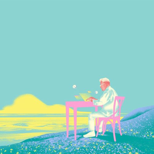 Man sitting at a desk writing near water at sunrise