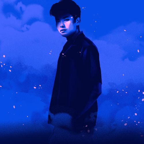 Young man standing with blue sky and clouds background