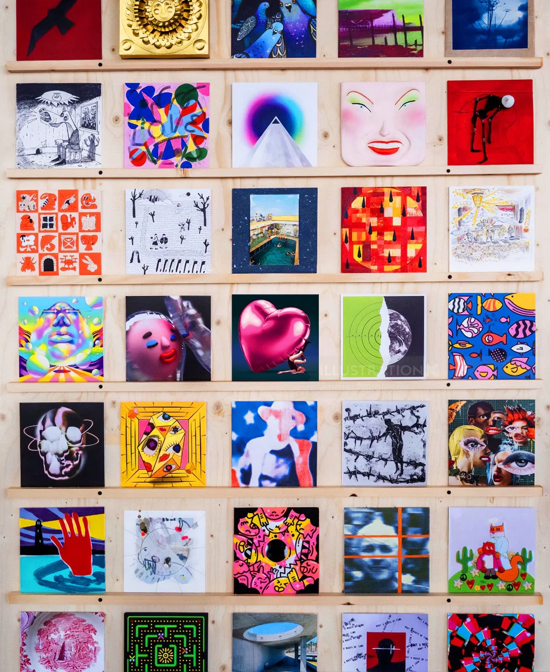 Wall display of colorful abstract and portrait artworks by Andrei Nicolescu