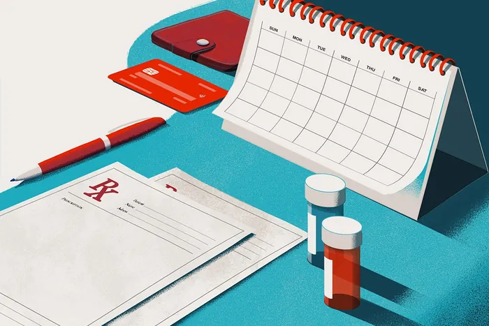Medication, calendar, and health organization tools on blue surface