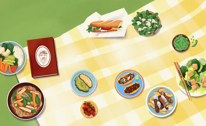 Table with diverse dishes and a menu on a yellow checkered tablecloth.