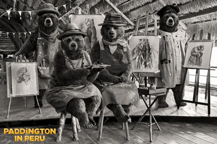 Three bears in vintage clothes with paintings in rustic building