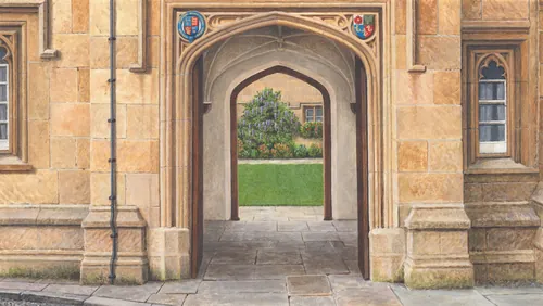 Arched stone entrance at Oxford University with visible green courtyard