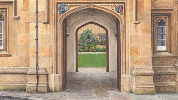 Arched stone entrance at Oxford University with visible green courtyard