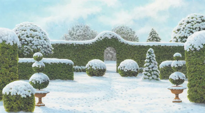 Snow-covered topiary garden with neatly trimmed bushes and blue sky