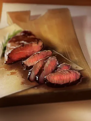 Sliced medium-rare steak on wooden board by Andriy Vynogradov