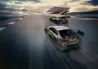 Two race cars speeding on a race track by artist Andriy Vynogradov