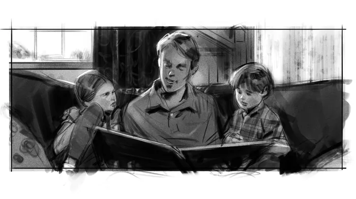 Man reading a book aloud to two attentive children on a couch