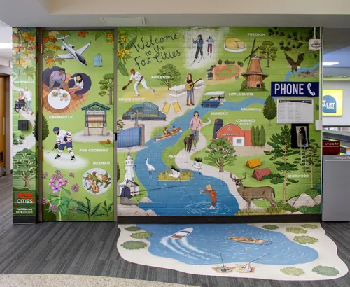 Mural at Appleton Airport welcoming visitors with local scenes by Annie Davidson