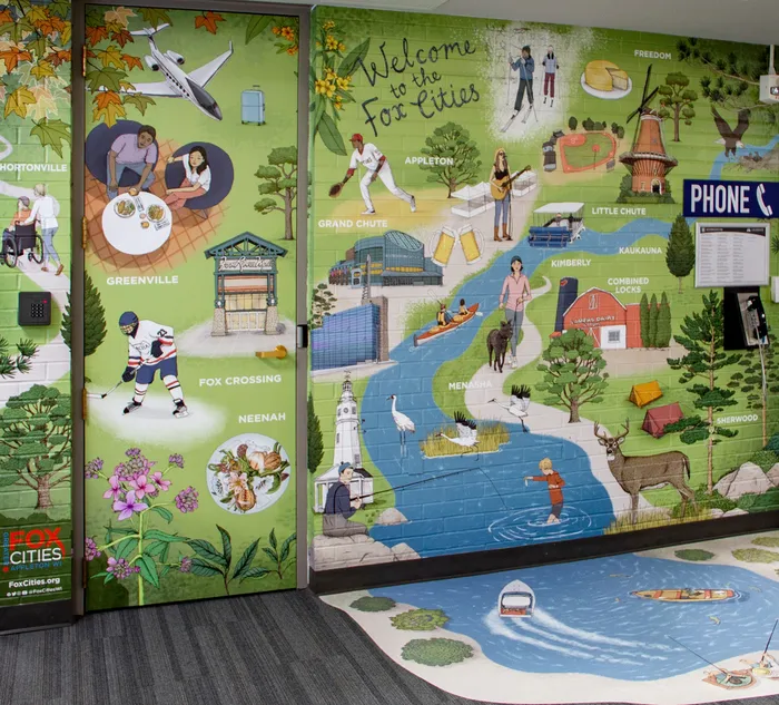 Annie creates a mural artwork for Appleton Airport